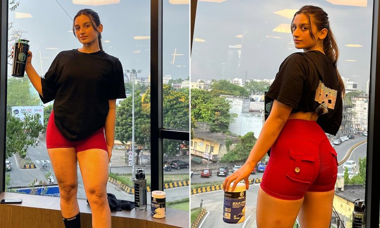 Swarnalee Chakraborty Wearing oversize black t-shirt and red shorts and promoting a brand