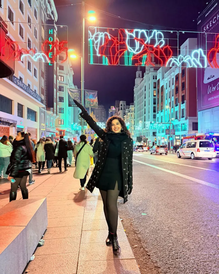 Kamiya Jani pose a photo on street wearing a black one piece dress
